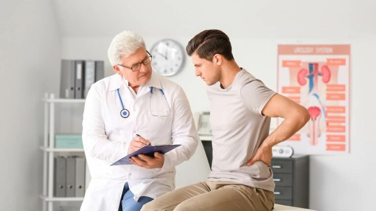 Médico urologista realizando atendimento com paciente homem.