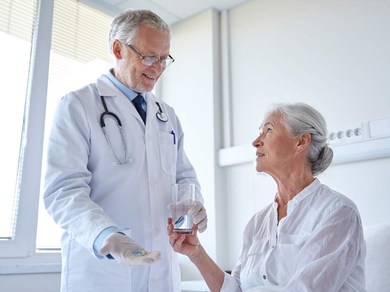 Médico medicando paciente mulher.