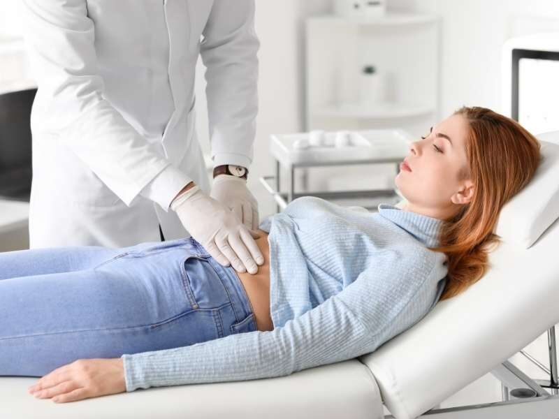Medico gastroenterologista examinando paciente.