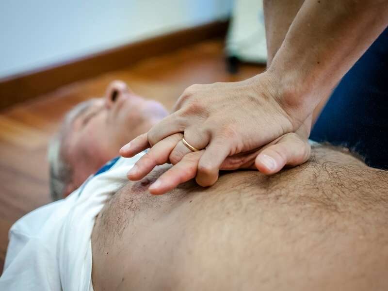 Homem recebendo massagem cardíaca.